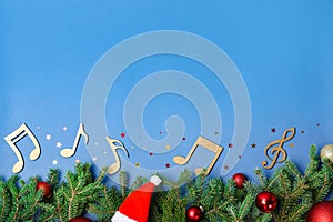 Flat lay composition with fir tree, Christmas decor and wooden music notes on color background