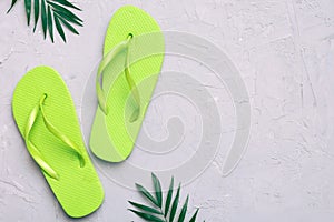 Flat lay composition with flip flops and seashell on colored background. Space for text top view