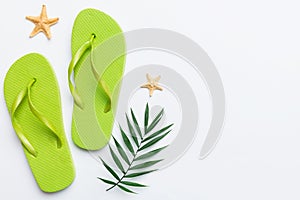 Flat lay composition with flip flops and seashell on colored background. Space for text top view