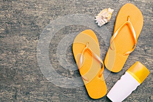 Flat lay composition with flip flops and seashell on colored background. Space for text top view