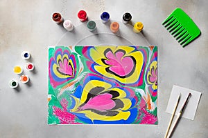 flat lay composition with floral pattern drawing and tools on table