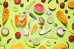 Flat lay composition with fresh organic fruits and vegetables on light green background