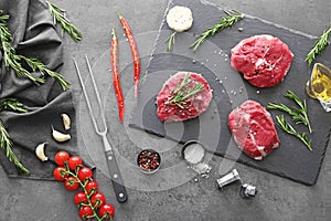Flat lay composition with fresh raw meat, vegetables and spices on table