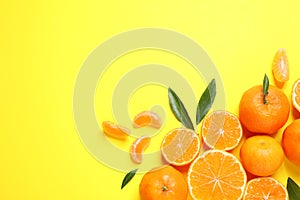 Flat lay composition with fresh ripe tangerines and leaves on background, space for text. Citrus fruit