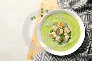 Flat lay composition with fresh vegetable detox soup made of green peas in dish and space for text