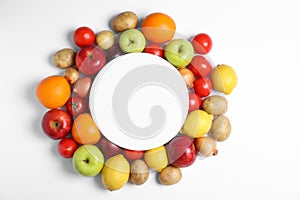 Flat lay composition with fresh vegetables, fruits and blank card on white background