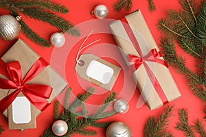 Flat lay composition with gift boxes and Christmas decor on red background