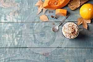 Flat lay composition with glass cup of tasty pumpkin spice latte and space for text