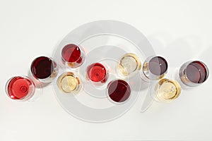 Flat lay composition. Glasses with different wine on white background