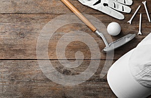 Flat lay composition with golf accessories on wooden background