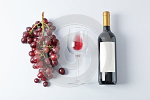 Flat lay composition with grapes, bottle and glass with wine
