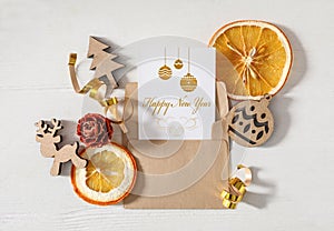 Flat lay composition with greeting card on white wooden table. Merry Christmas