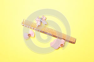 Flat lay composition with hair comb on yellow background