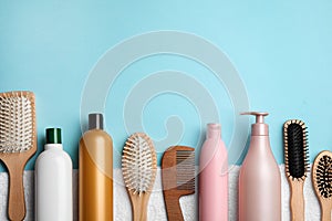 Flat lay composition with hair cosmetic products and tools on blue background