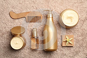 Flat lay composition with hair cosmetic products on towel