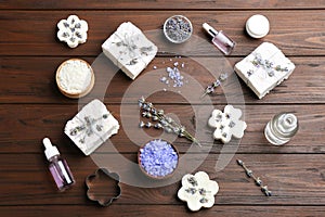 Flat lay composition with hand made soap bars and lavender flowers on table