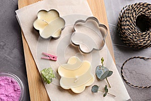 Flat lay composition of handmade candles with cutters photo