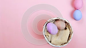 Flat lay composition of Happy Easter holiday concept. Colorful egg in row on pink background. Space for design, top view.