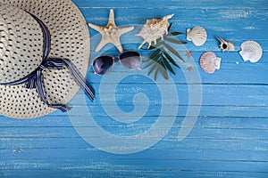 Flat lay composition with hat, sunglasses and seashells