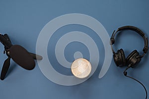 Flat lay composition with Headphones, microphone and coffee on a blue background. Podcast or webinar concept