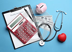 Flat lay composition with health insurance form, calculator and stethoscope