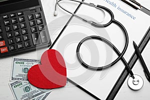 Flat lay composition with health insurance form, red heart and stethoscope on wooden background