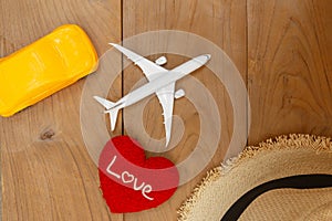 Flat lay  composition with heart shape and  airplane model ,toy car on wooden background .