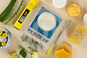 Flat lay composition with homemade cosmetic products and fresh ingredients on beige background