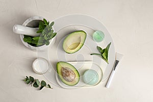 Flat lay composition with homemade cosmetic products and fresh ingredients on white table