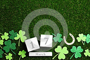 Flat lay composition with horseshoe and block calendar, space for text. St. Patrick`s Day celebration