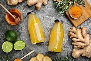 Flat lay composition with immunity boosting drink in bottles on grey table