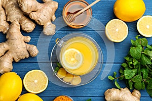 Flat lay composition with immunity boosting drink and ingredients on blue wooden table