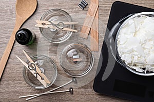 Flat lay composition with ingredients for homemade candles on wooden background photo