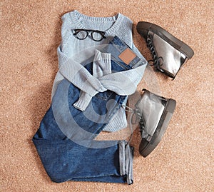 Flat lay composition with jeans, sweater and shoes