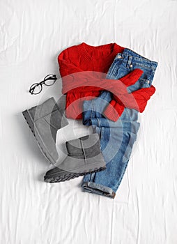 Flat lay composition with jeans, sweater and shoes