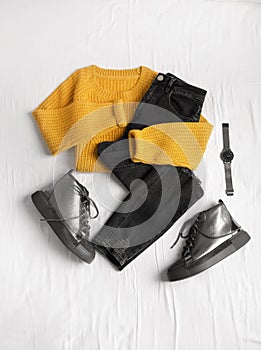 Flat lay composition with jeans, sweater and shoes