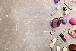 Flat lay composition with , jewelry and cosmetic products on marble table, space for text
