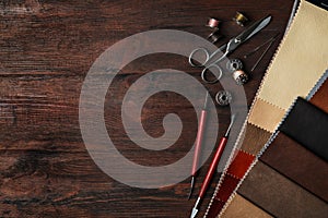 Flat lay composition with leather samples and tools on table. Space for text