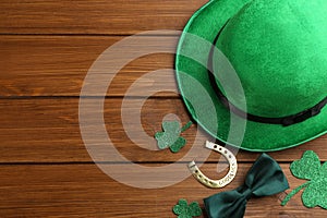 Flat lay composition with leprechaun hat on wooden table, space for text. St Patrick`s Day celebration