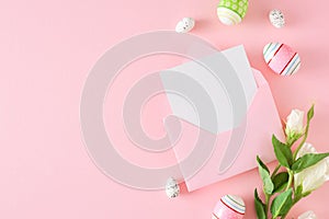 Flat lay composition made of Easter eggs, envelope with letter and flowers