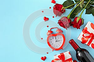 Flat lay composition made of red roses, wine bottle, gift box, alarm clock, red hearts