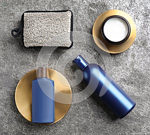 Flat lay composition with men`s cosmetics on grey stone background
