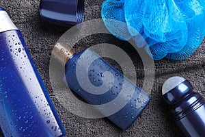 Flat lay composition with men`s cosmetics on grey towel