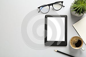 Flat lay composition with modern e-book reader on white background, space for text