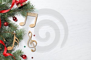 Flat lay composition with music notes on white wooden background, space for text. Christmas celebration