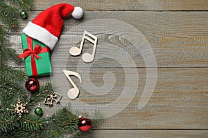 Flat lay composition with music notes on wooden background, space for text. Christmas celebration