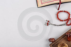 Flat lay composition with Muslim prayer beads, Quran and space for text