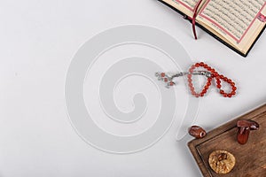 Flat lay composition with Muslim prayer beads, Quran and space for text