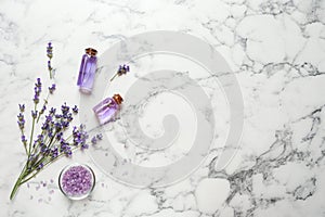 Flat lay composition with natural cosmetic products and lavender flowers on marble background