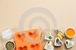 Flat lay composition with natural handmade soap and ingredients on background. Space for text